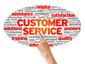 Hand pointing at a Customer Services Word illustration on white background.