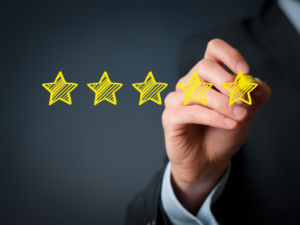 Increase rating evaluation and classification concept. Businessman draw five yellow star to increase rating of his company.