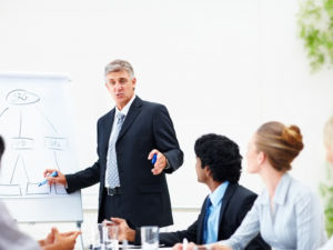 Senior business man during a training with his colleagues