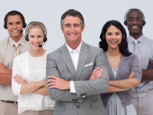 Smiling confident multi-ethnic team working in a call center